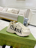 Cream Gucci unisex sneakers with 'thank' script on side, lace-up design