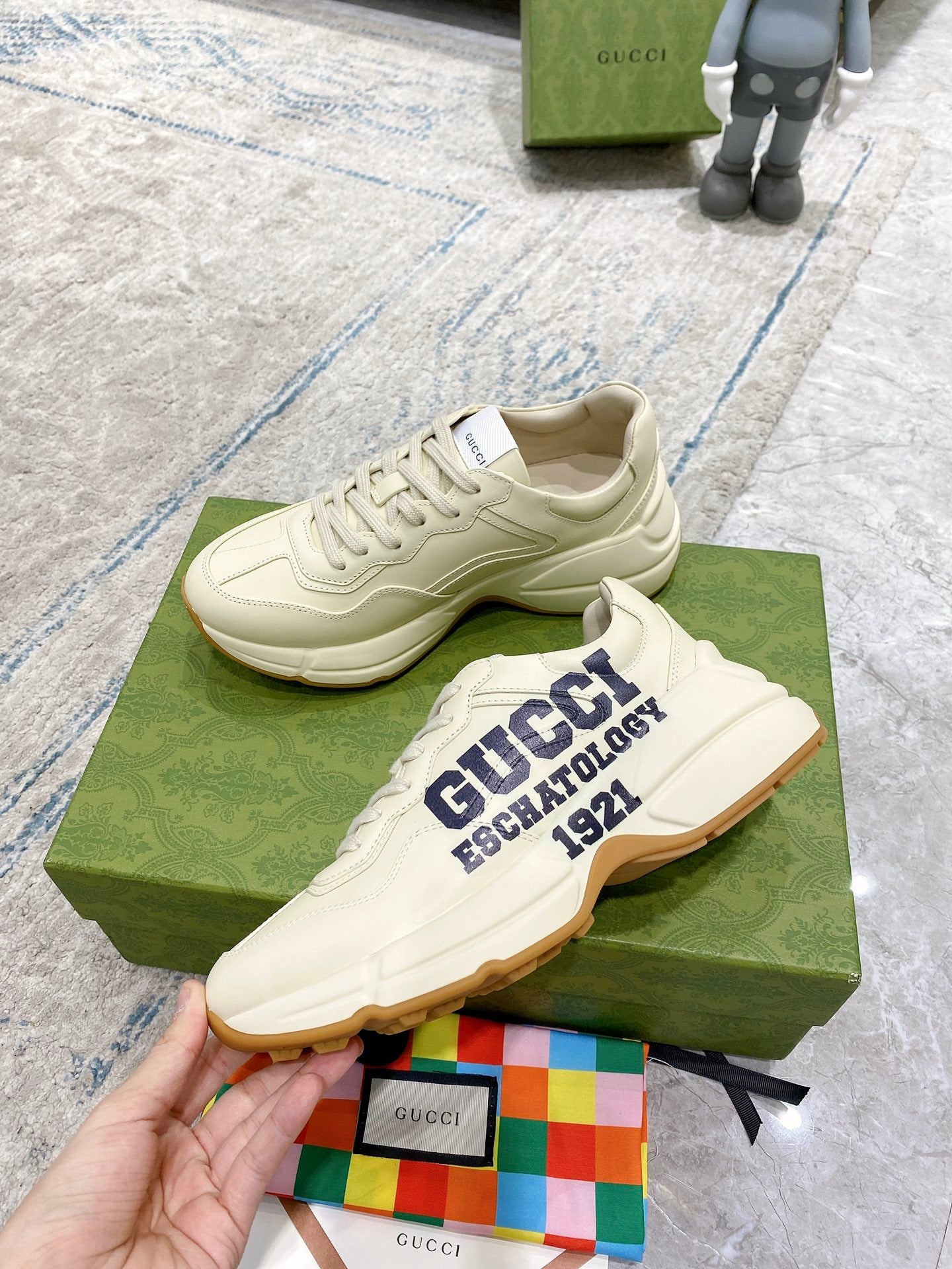 Cream lace-up sneakers with "GUCCI ESCHATOLOGY 1921" logo