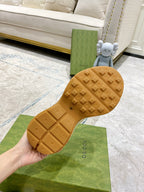 Cream sneaker outsole tread with Gucci branding, bottom view