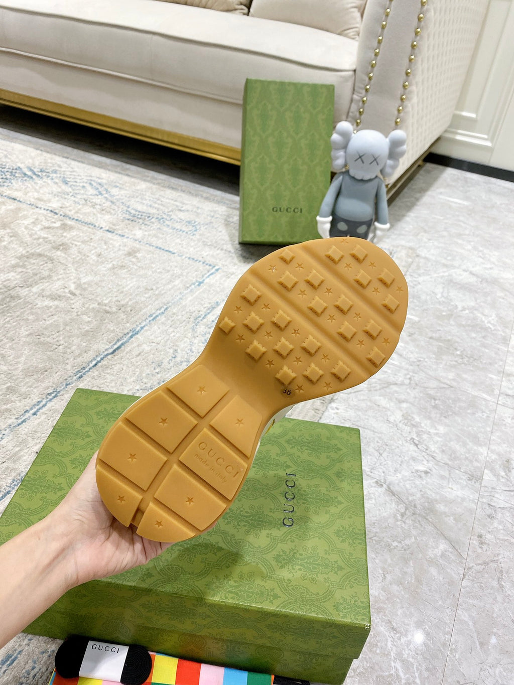 Gucci unisex sneakers outsole, tan rubber tread sole shown from below