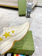 Gucci unisex sneakers side view, white upper with yellow stars and stitched panels
