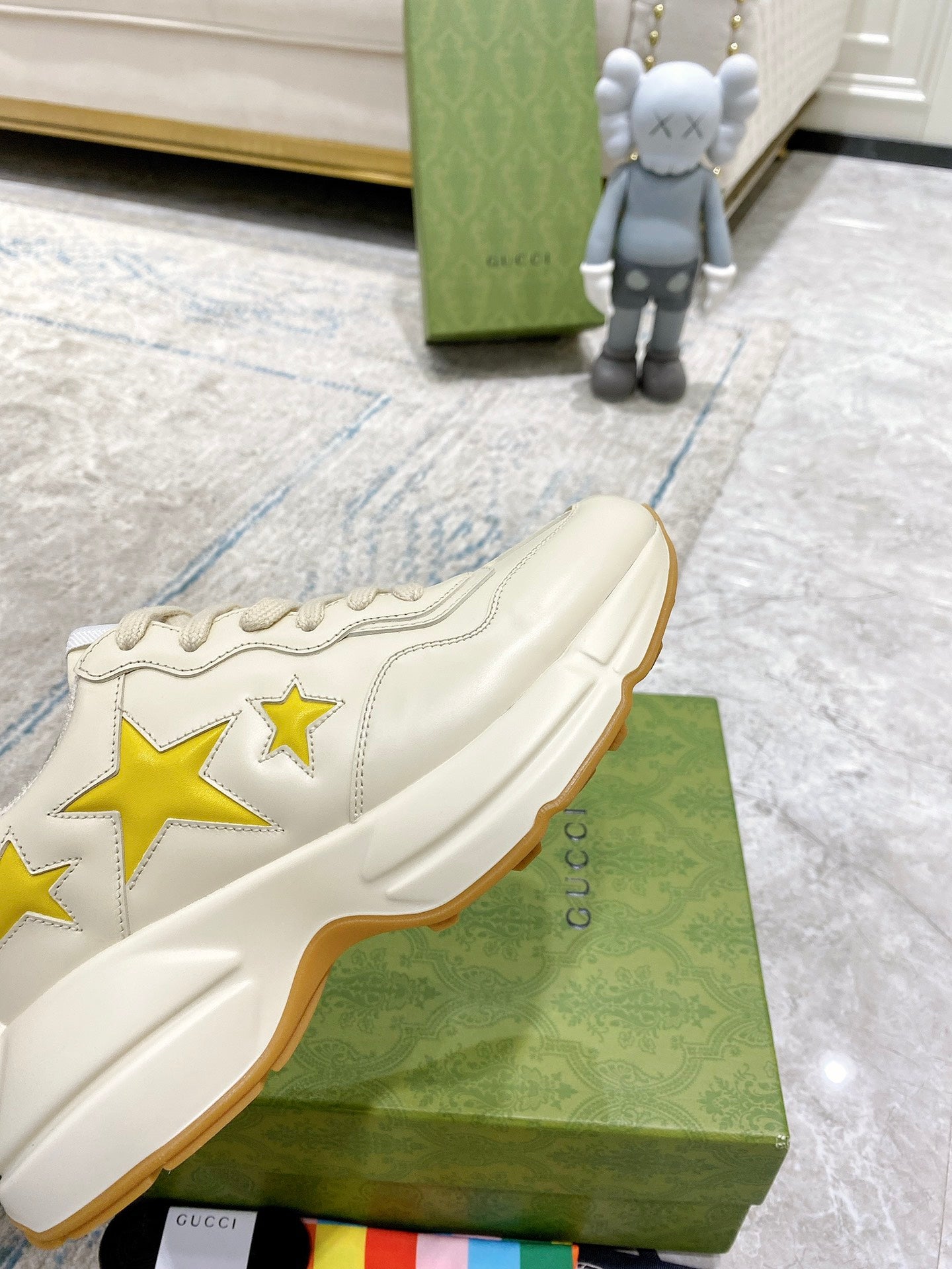Gucci unisex sneakers side view, white upper with yellow stars and stitched panels