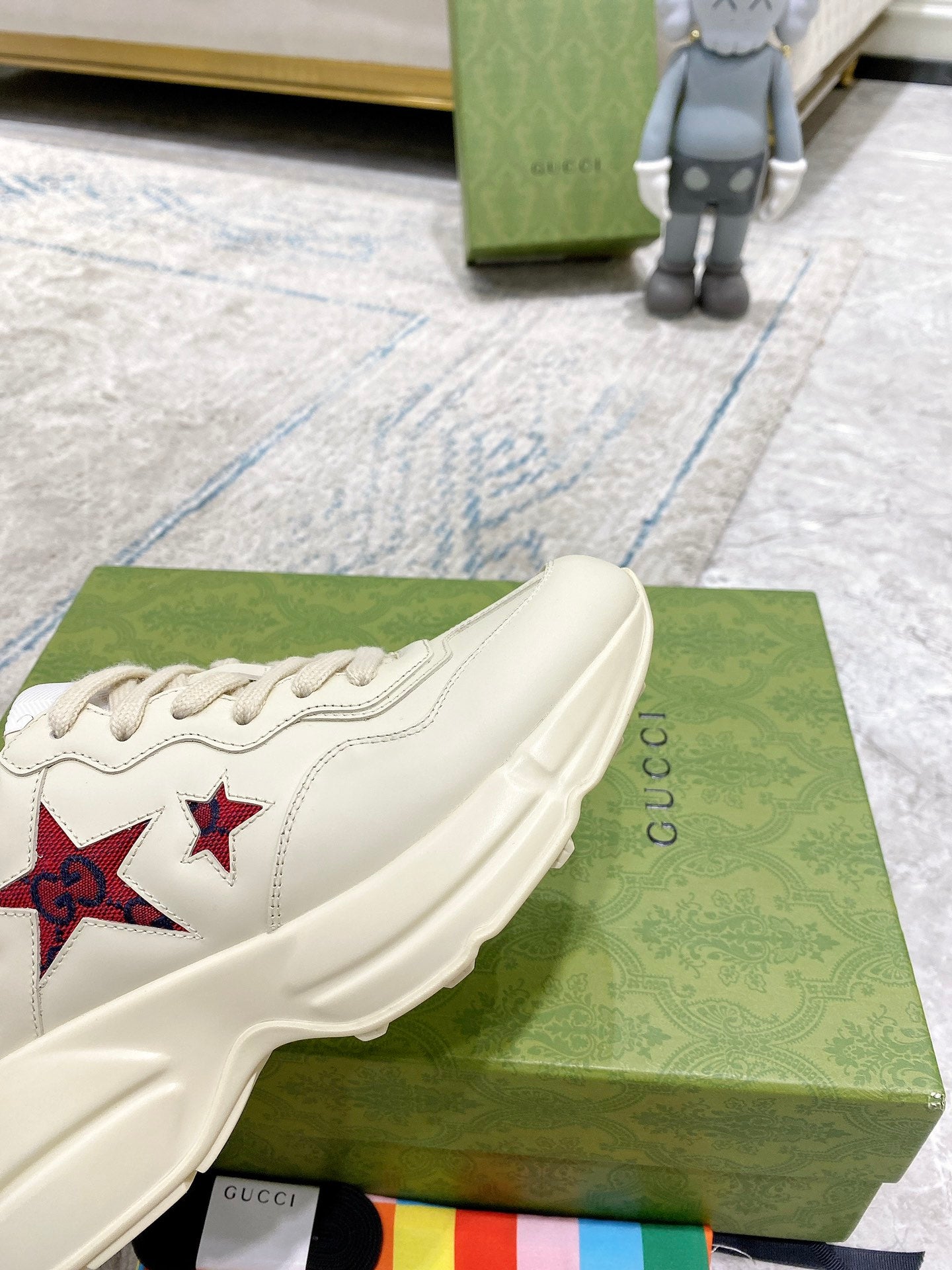Gucci unisex white sneakers, side view showing padded sole and lace-up