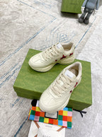 Gucci unisex white sneakers with red star accents, front and side view