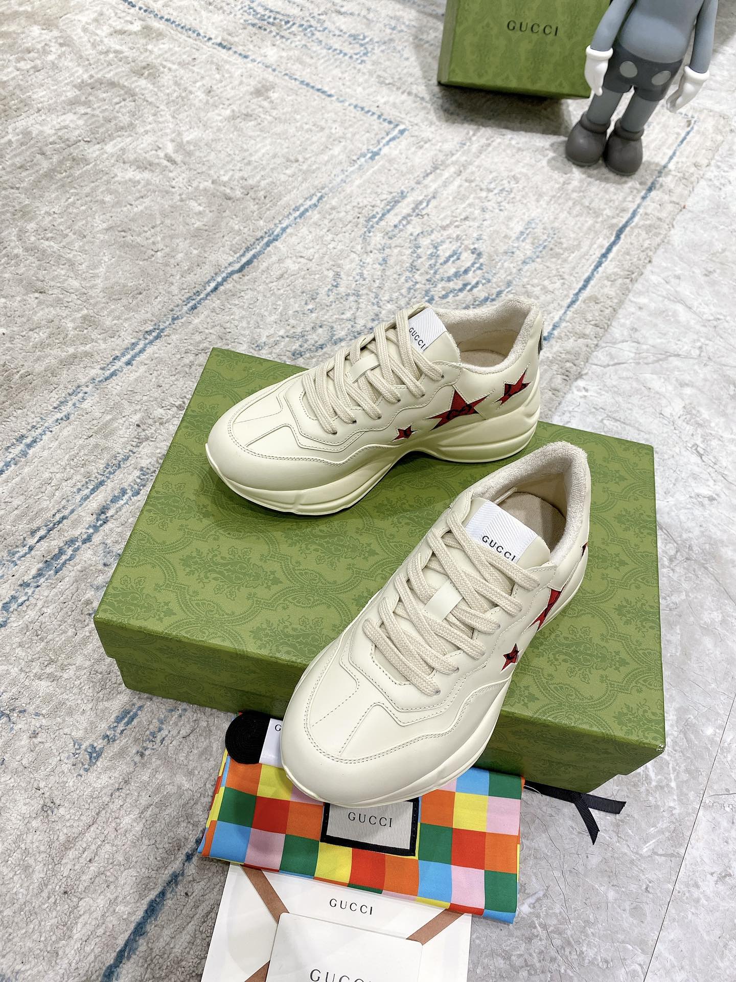 Gucci unisex white sneakers with red star accents, front and side view