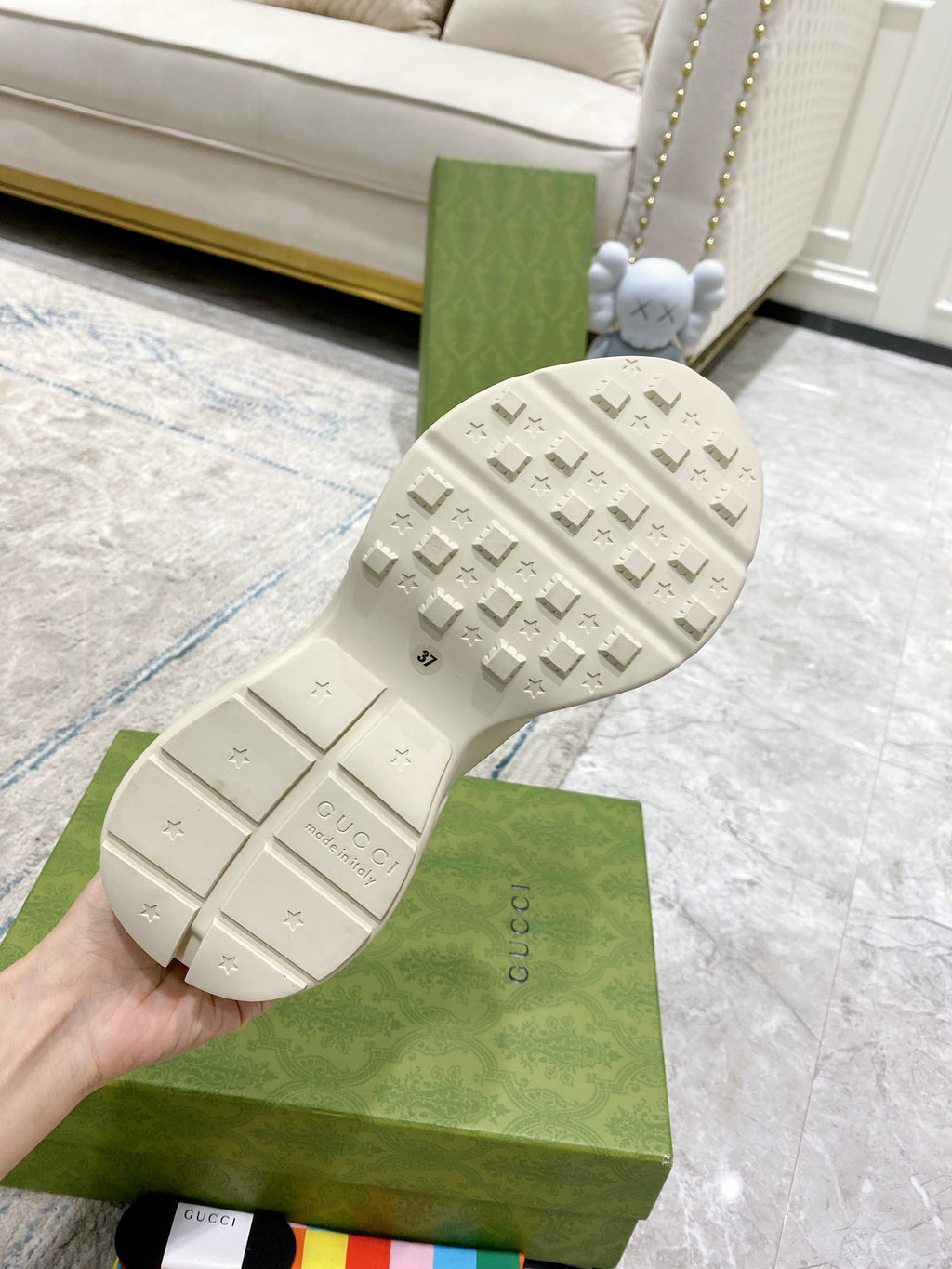 Gucci white sneaker outsole with tread pattern and embossed Gucci logo