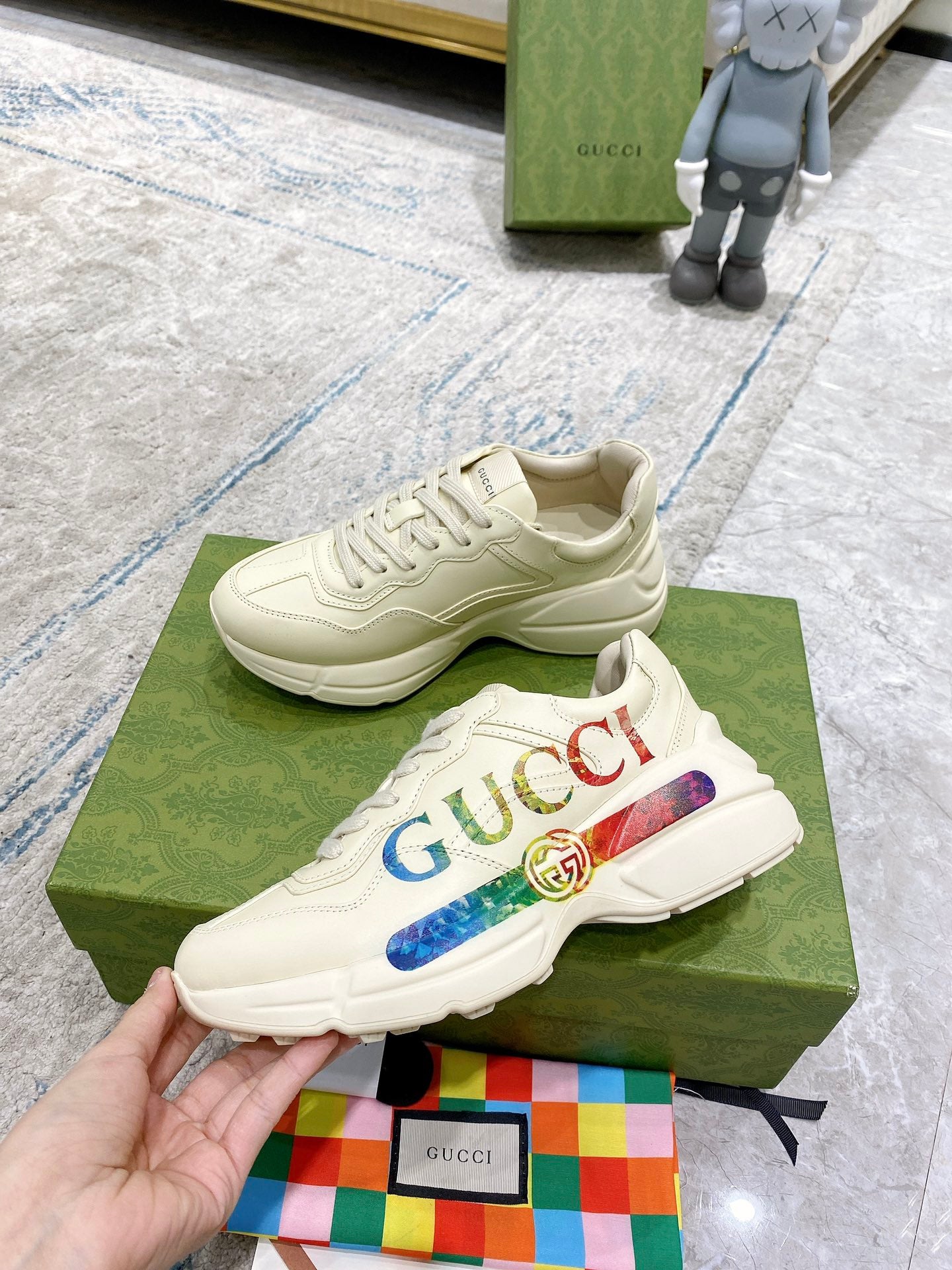 Gucci unisex luxury sneakers, white lace-up pair with multicolor logo stripe detail
