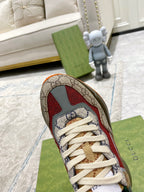 Gucci GG sneaker close-up: beige canvas with red accents, white laces, green lining