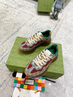 Gucci sneaker pair on box: beige GG canvas, red details, white laces, green inner lining