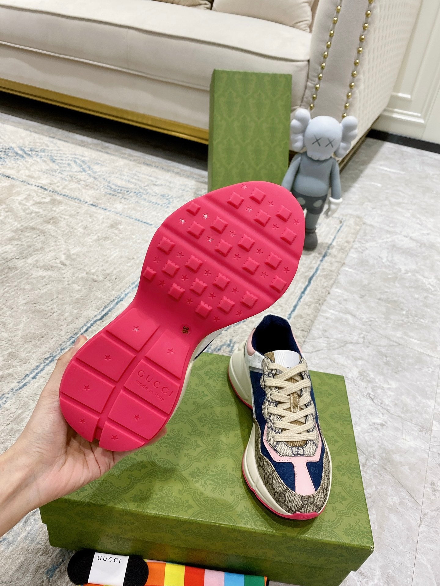Gucci unisex luxury sneaker outsole view with red rubber tread and beige upper