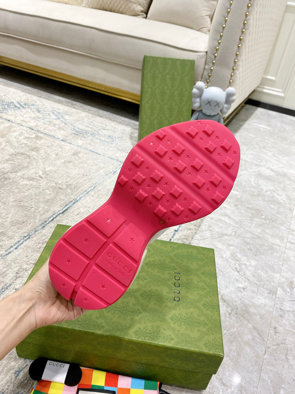 Gucci unisex sneaker outsole detail: red rubber tread with embossed logo
