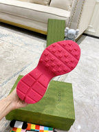 Gucci unisex sneaker outsole detail: red rubber tread with embossed logo
