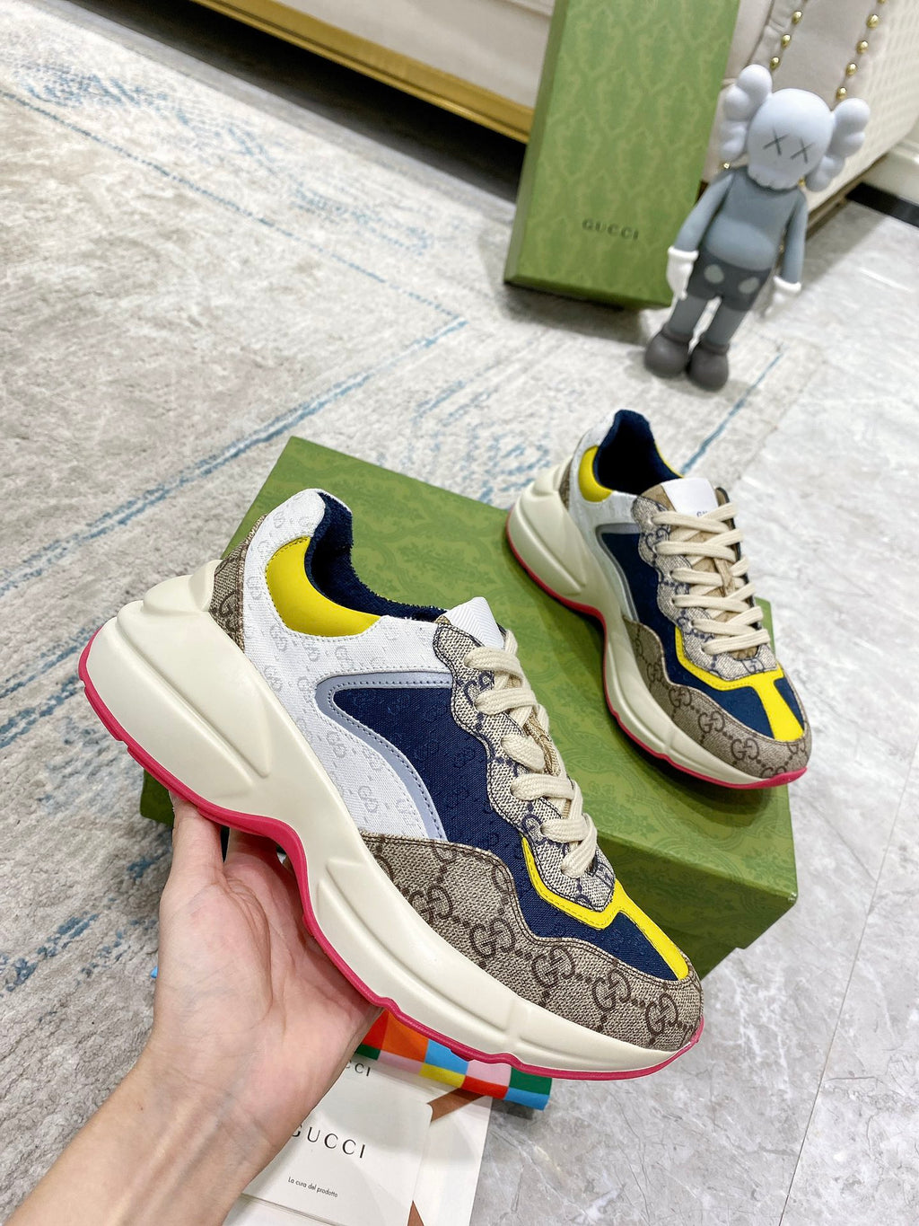 Gucci unisex sneakers side view: cream uppers with navy overlays, yellow accent