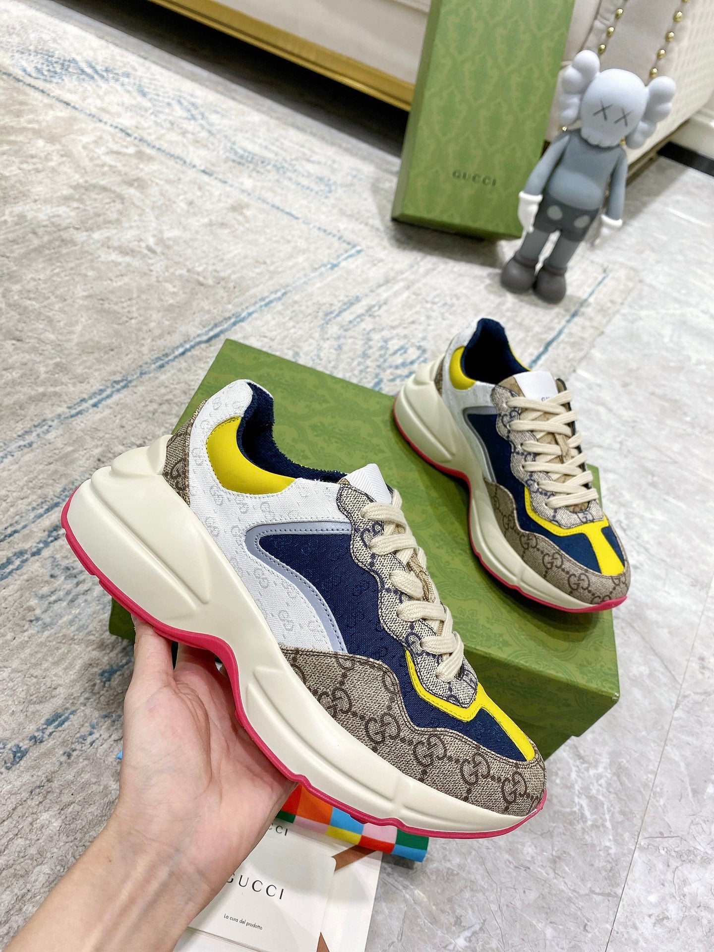 Gucci unisex sneakers side view: cream uppers with navy overlays, yellow accent