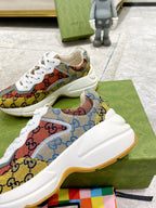 Close-up of canvas sneakers with multicolor GG print and thick white midsole
