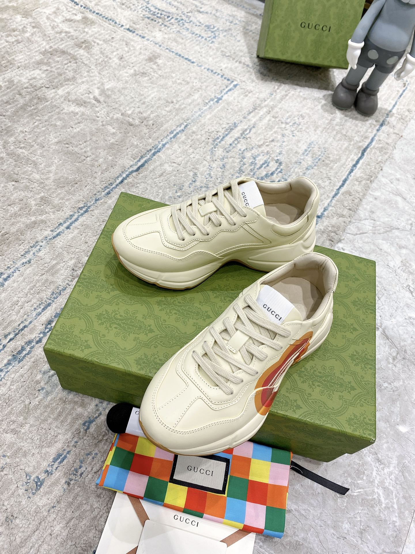 White Gucci unisex lace-up sneaker on green box, stitched details and heart stripe