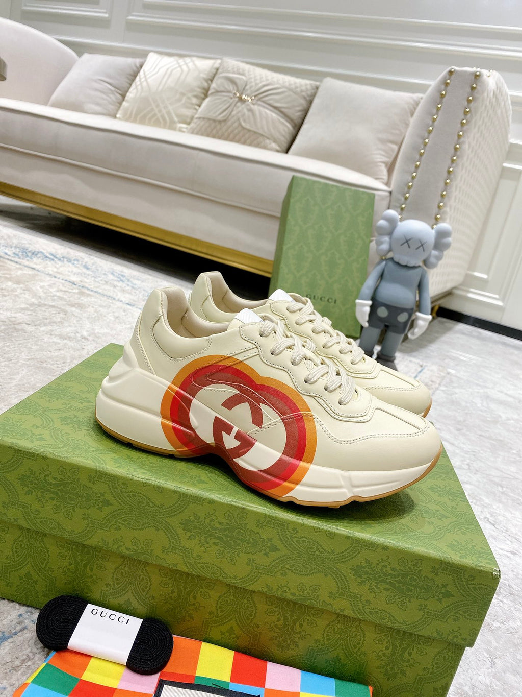 White Gucci unisex sneaker with multicolor heart logo on side, lace-up design