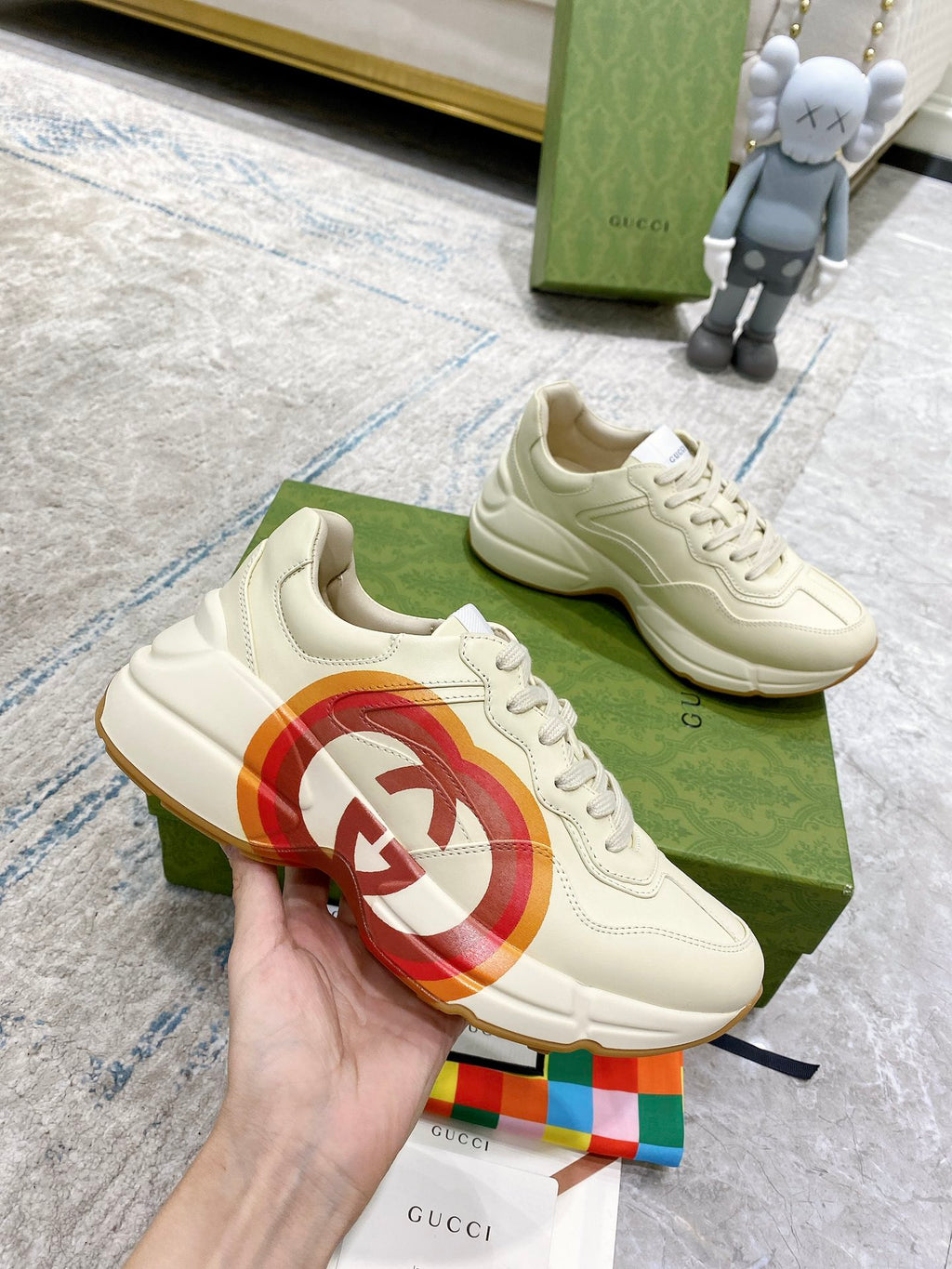 White Gucci unisex sneaker close-up with multicolor heart logo on side panel