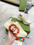 White Gucci unisex sneaker close-up with multicolor heart logo on side panel