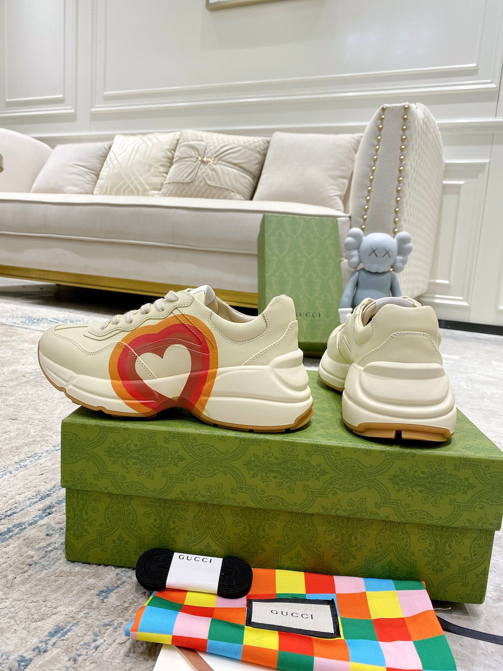 White Gucci unisex sneakers on boxes, heart stripe logo and lace-up style
