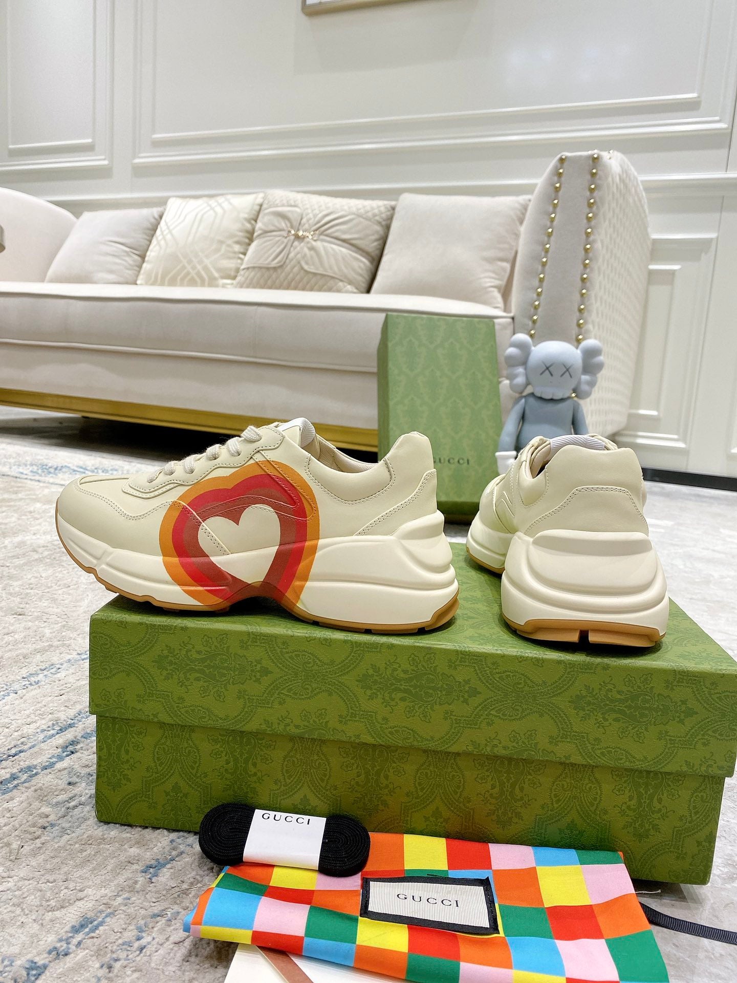 White Gucci unisex sneakers on boxes, heart stripe logo and lace-up style