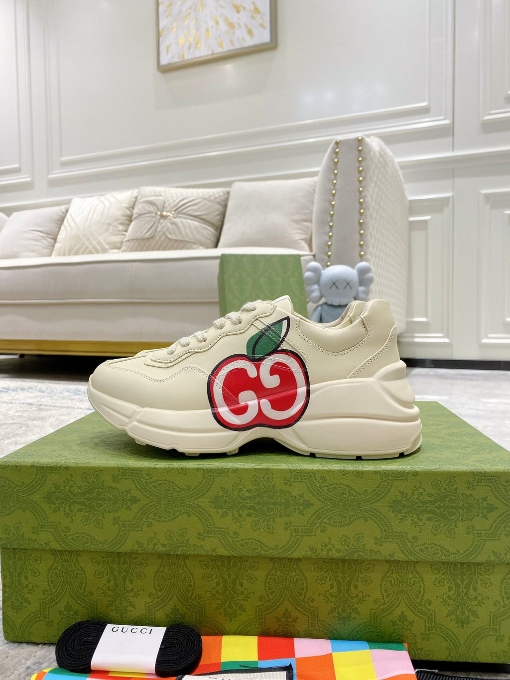 Cream Gucci low-top sneakers with red-and-green GG logo on the side