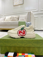 Cream Gucci low-top sneakers with red-and-green GG logo on the side