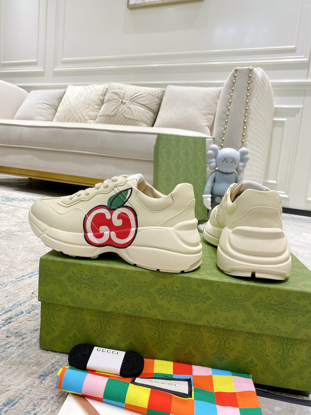 Cream Gucci sneakers with red-and-green GG logo and thick rubber sole