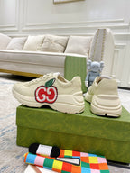 Cream Gucci sneakers with red-and-green GG logo and thick rubber sole