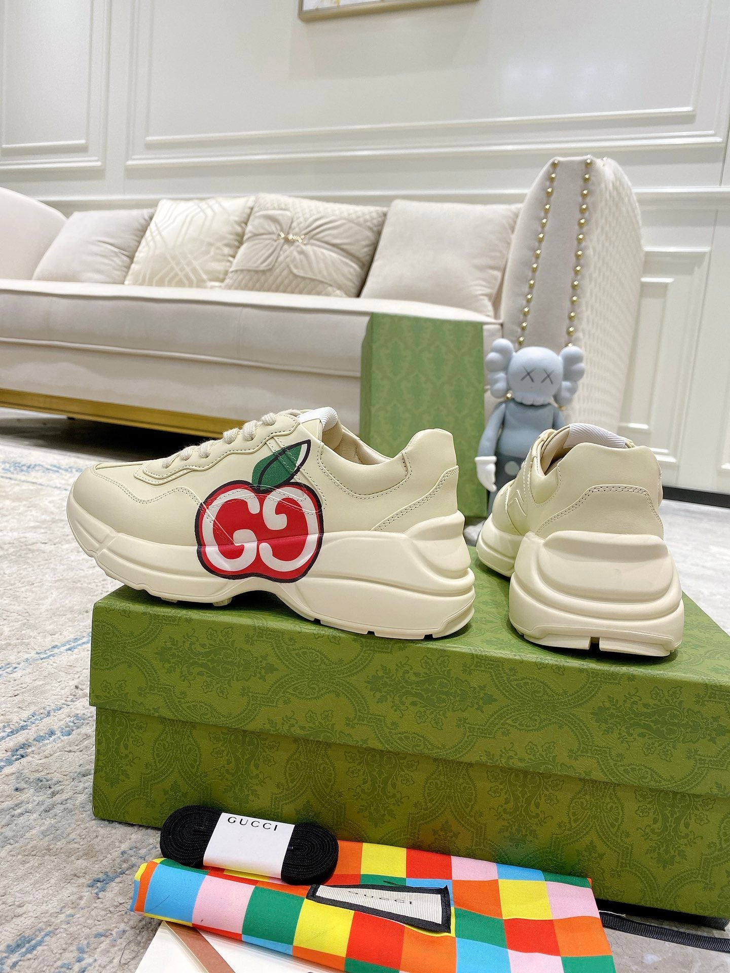Cream Gucci sneakers with red-and-green GG logo and thick rubber sole