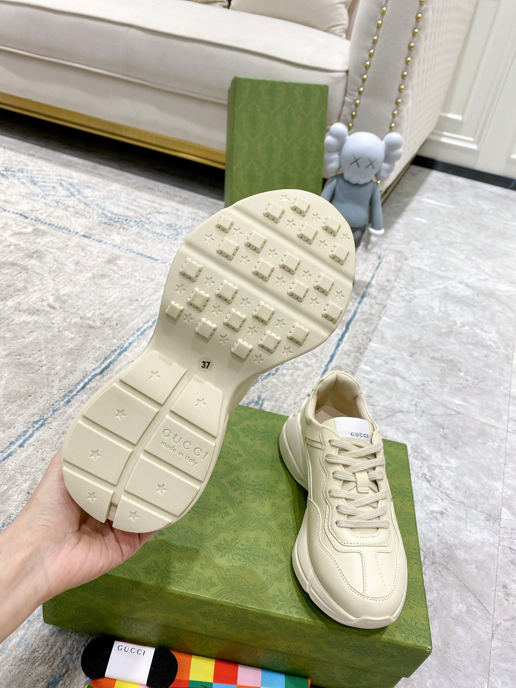 Cream Gucci sneaker outsole view with tread and lace-up upper