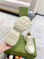 Cream Gucci sneaker outsole view with tread and lace-up upper