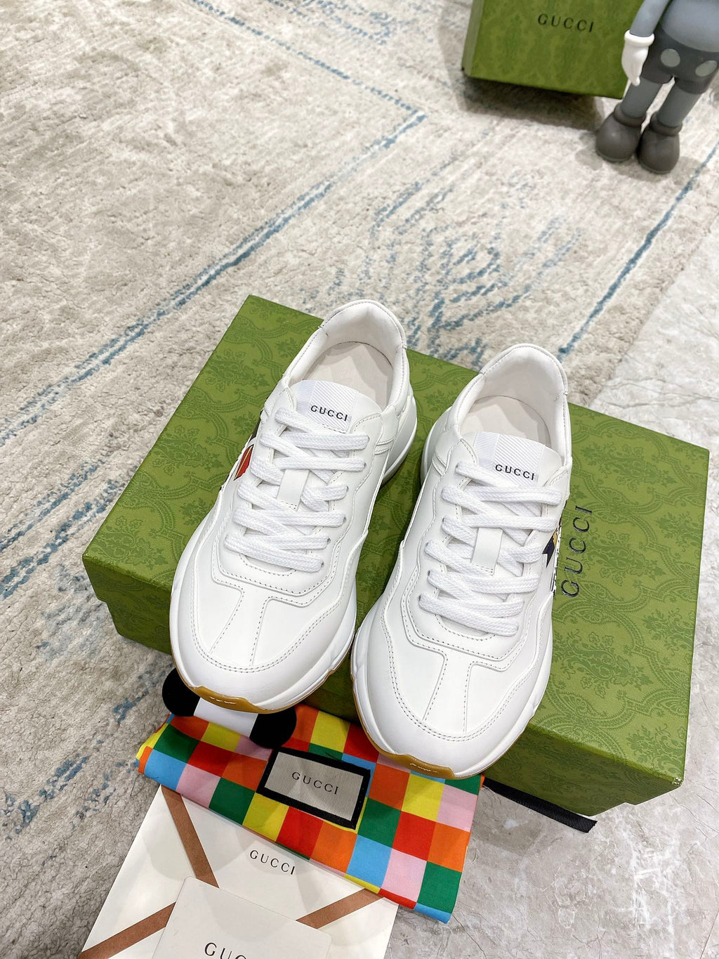 White Gucci unisex sneakers, lace-up style with WORLDWIDE text