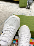 White Gucci unisex sneakers with lace-up detail and stitched panel