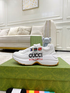White Gucci unisex sneakers on green box with multicolor logo patch