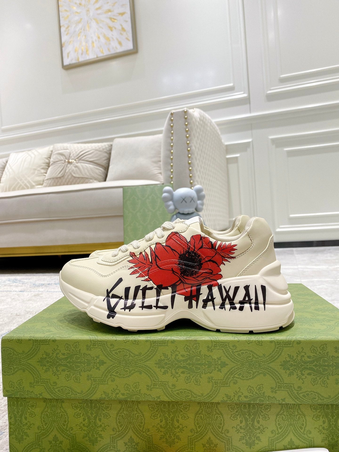 Gucci unisex sneakers, side view of white pair with red flower patch and black text