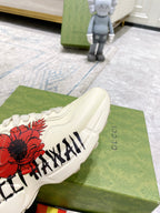 Gucci unisex sneakers, white shoe side with red flower print and black lettering