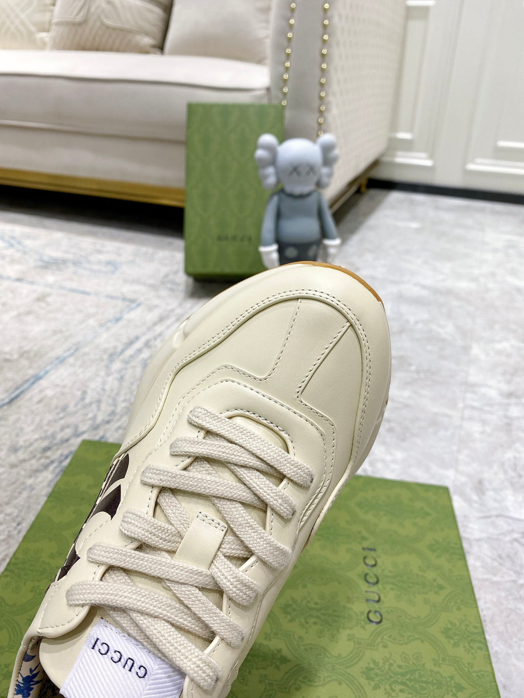 Gucci unisex sneaker in light cream, side profile with black NY logo and lace-up