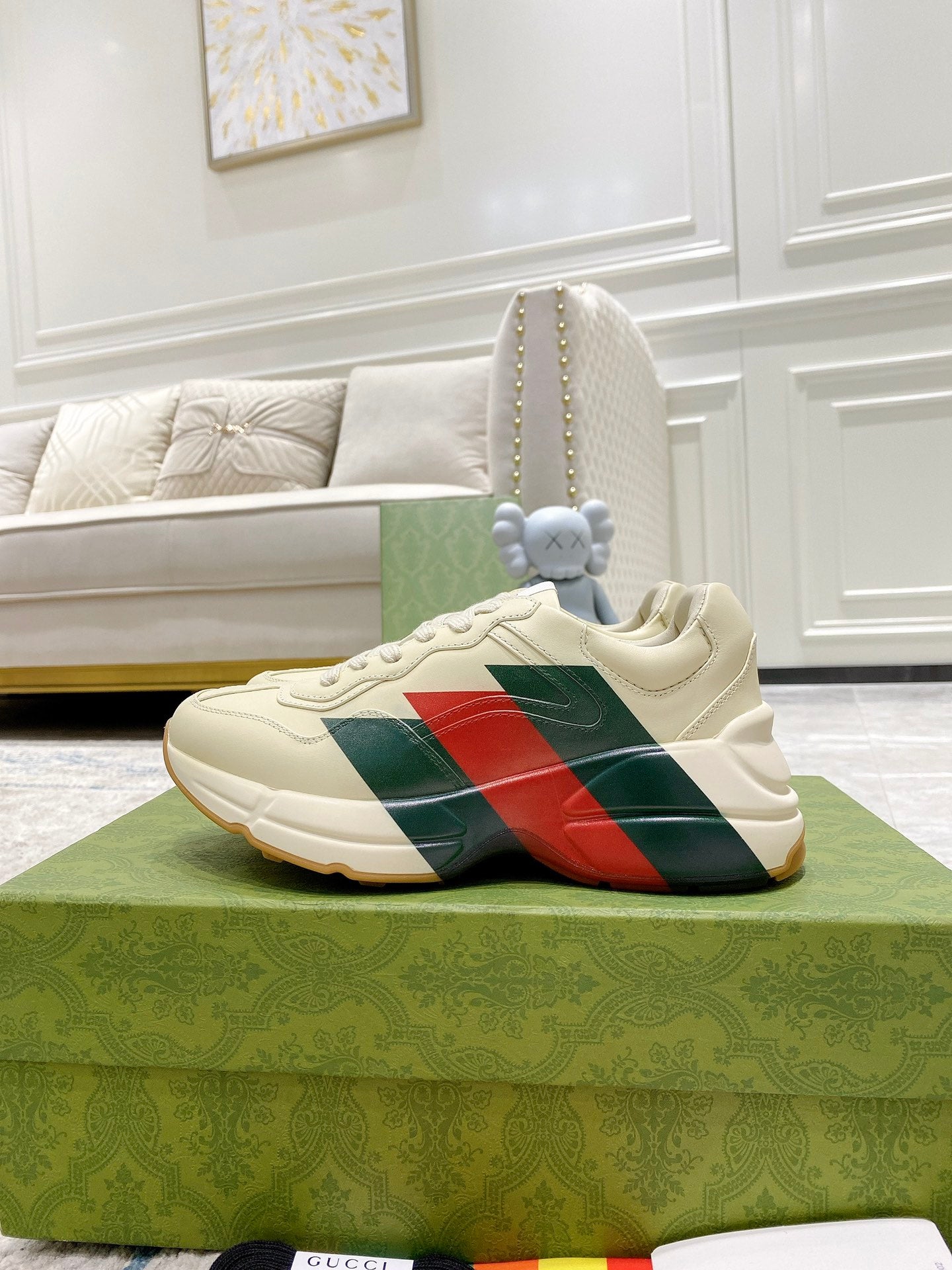 Unisex white sneaker with red and green stripe across the side, lace-up design.