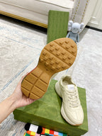 Unisex white sneaker outsole and side view; tread pattern and lace-up upper shown.