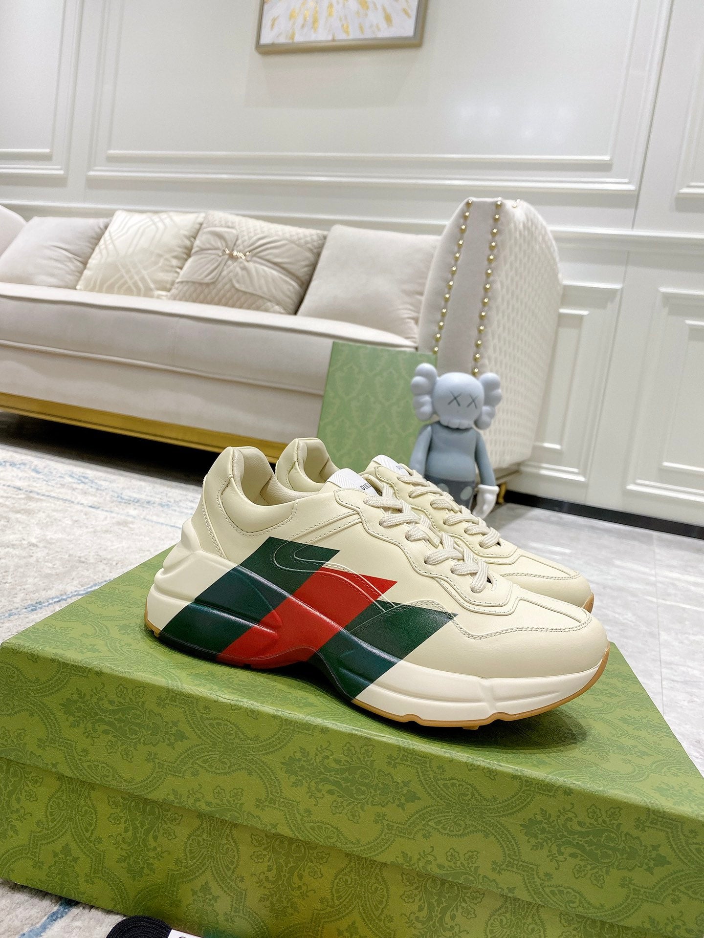 Unisex white leather sneakers with red and green stripe panel, lace-up front.
