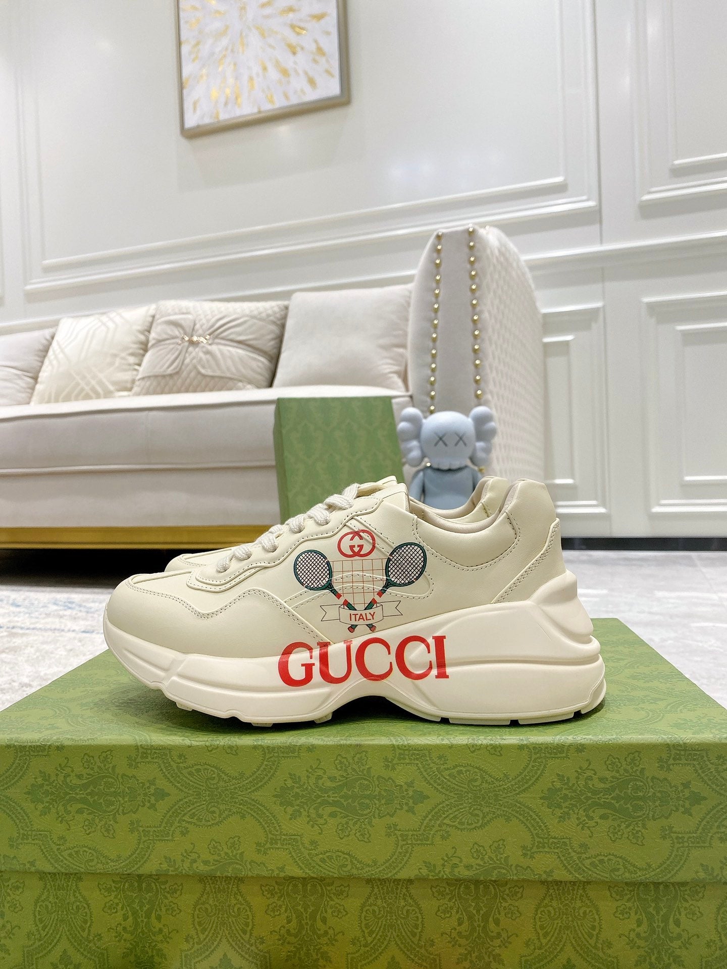 Cream unisex Gucci sneakers, lace-up design with red GUCCI logo on the side