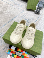 Pair of cream unisex Gucci sneakers with tennis graphic and white laces