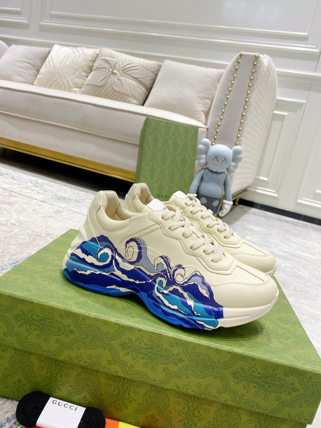 White Gucci unisex sneakers with blue wave graphic and lace-up design
