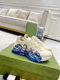 White Gucci unisex sneakers with blue wave graphic and lace-up design