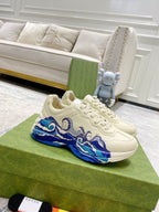 White Gucci unisex sneakers with blue wave graphic and lace-up design