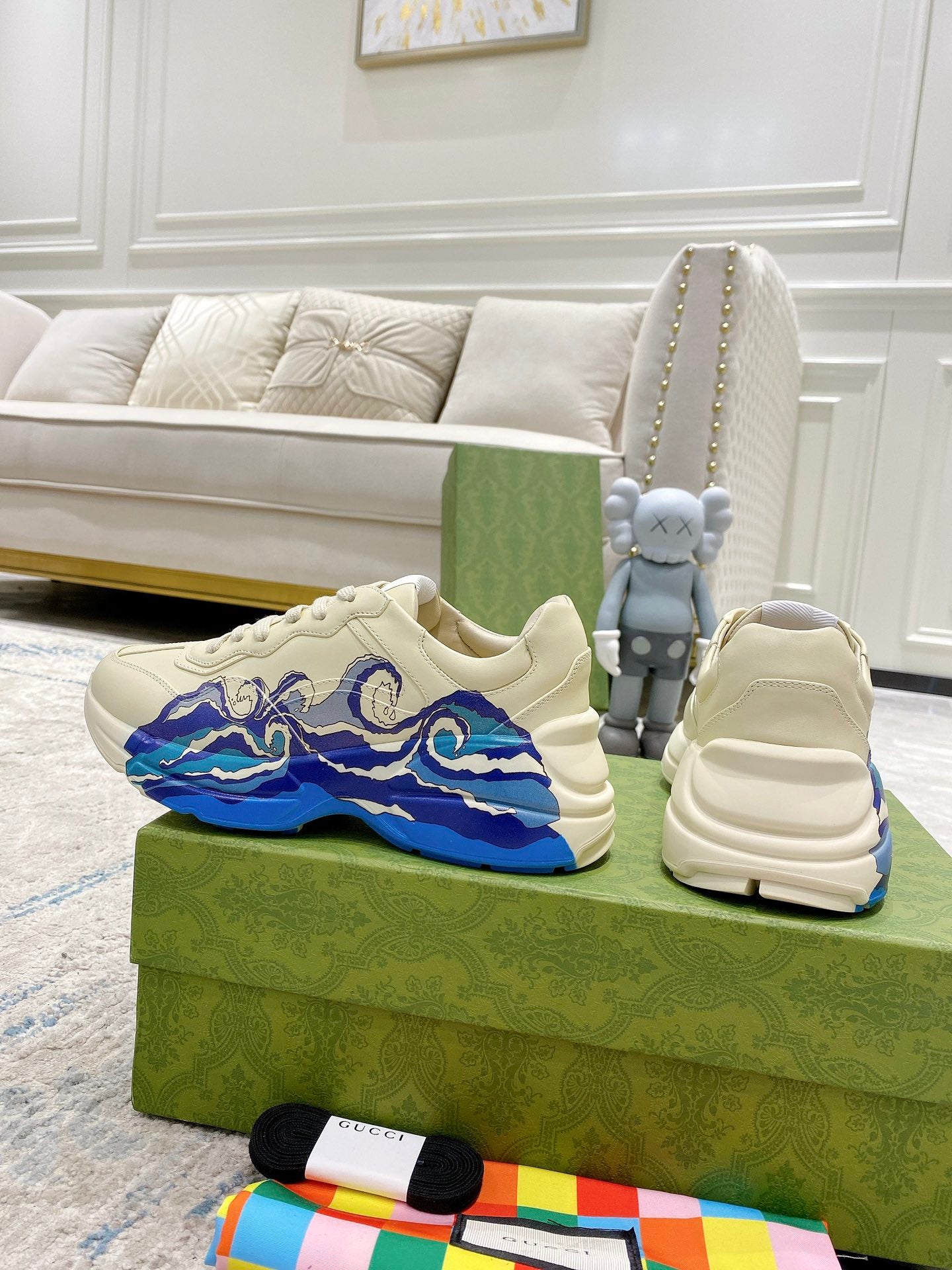 Pair of white Gucci unisex sneakers, blue wave side graphic, shown with box