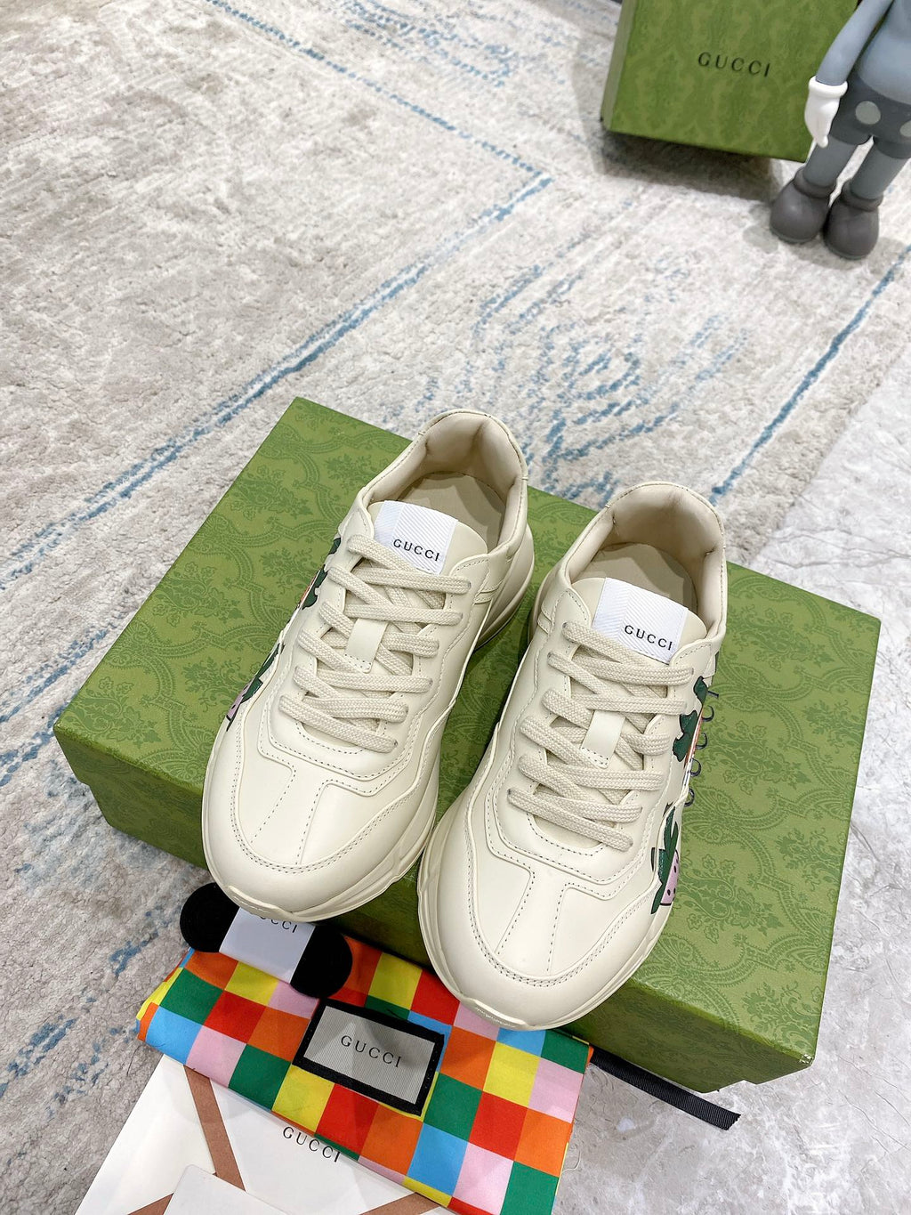 Gucci unisex sneakers, cream lace-up with large strawberry print on sides; matching uppers.