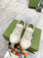 Gucci unisex sneakers, cream lace-up with large strawberry print on sides; matching uppers.