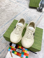 Gucci unisex cream lace-up sneakers on box, with visible laces and logo patch